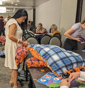 Corporate team making shelters snuggles pet bed